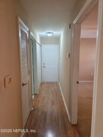 a view of an empty room with a fireplace and a window