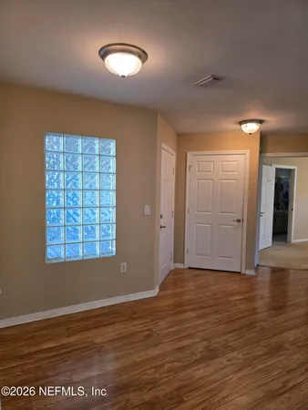 wooden floor in an empty room with a window