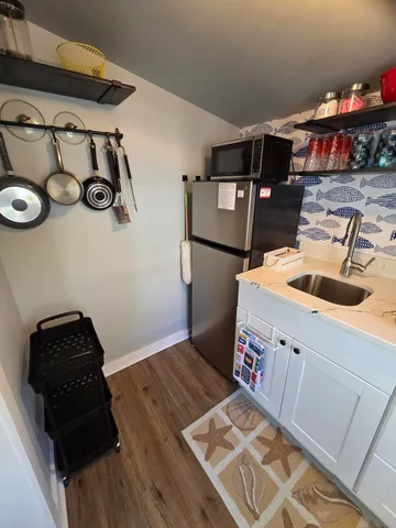 a bedroom with a bed and a flat tv screen on the dresser
