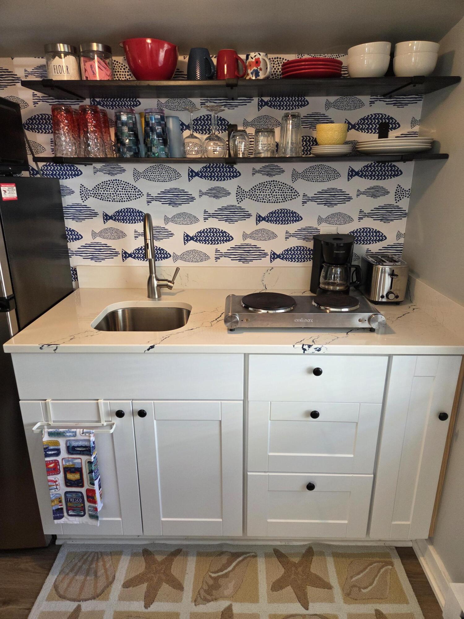 1061 State Highway, Unit 4 Eastham, MA 02642 - Photo 15 of 27 a kitchen with stainless steel appliances granite countertop a sink and cabinets