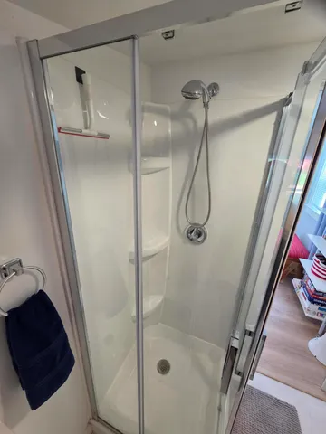 a bathroom with a glass shower door