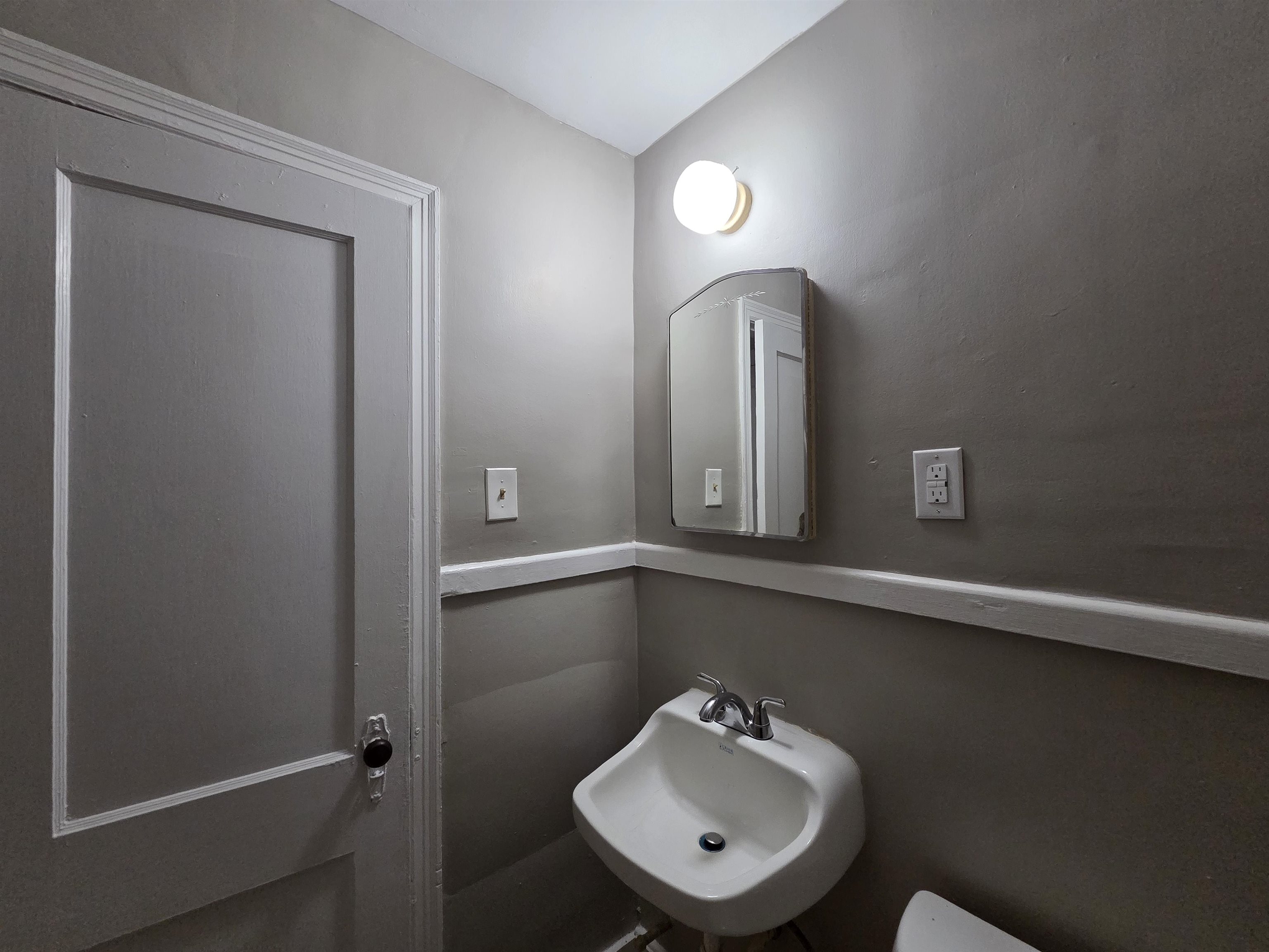 802 North Dunlap Street Memphis, TN 38107 - Photo 12 of 18 a bathroom with a sink and a mirror