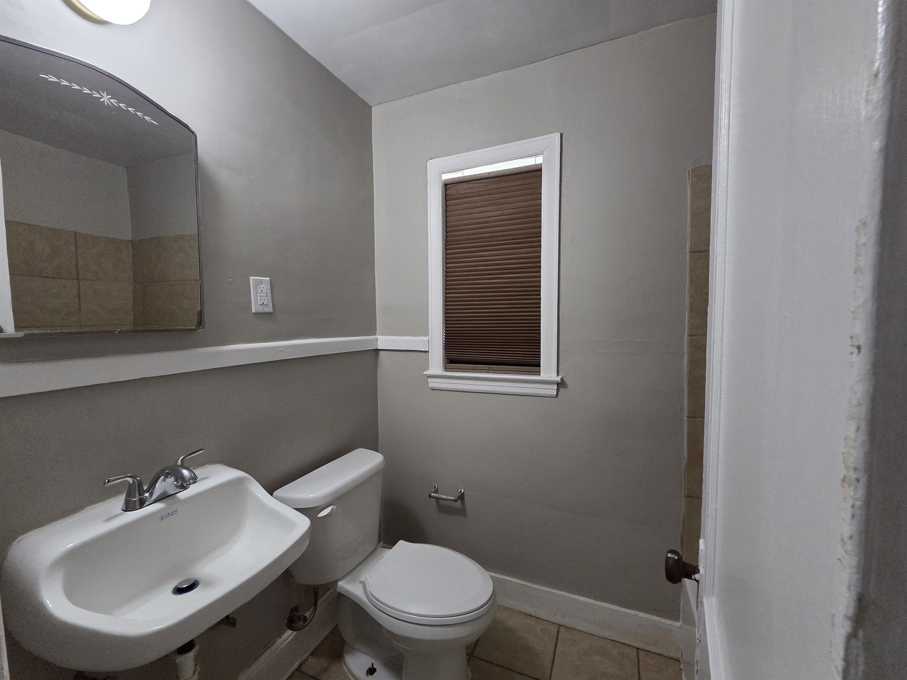 802 North Dunlap Street Memphis, TN 38107 - Photo 14 of 18 a bathroom with a sink mirror and toilet