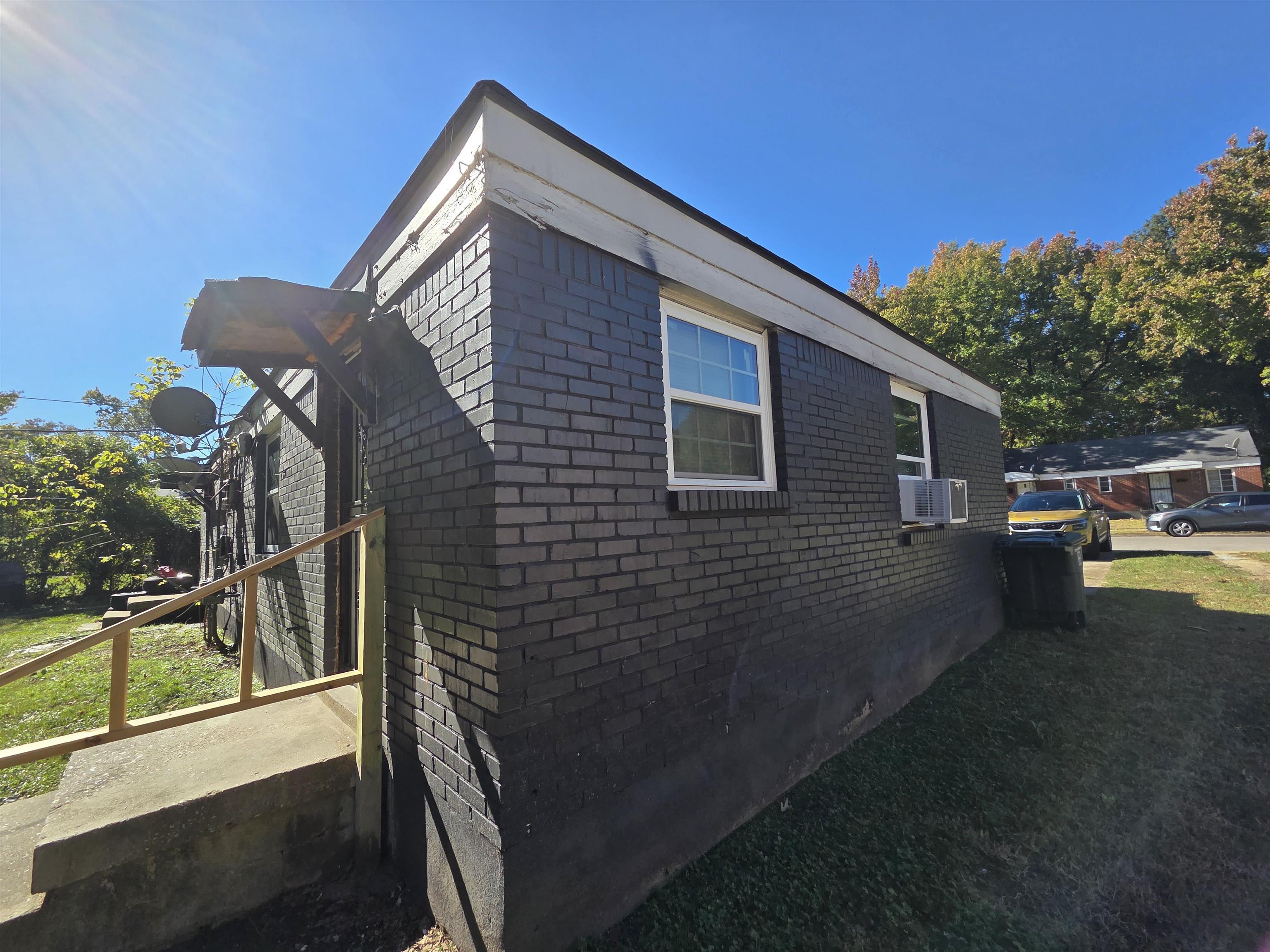 802 North Dunlap Street Memphis, TN 38107 - Photo 3 of 18 View of home's exterior with brick siding, crawl space, cooling unit, and a yard