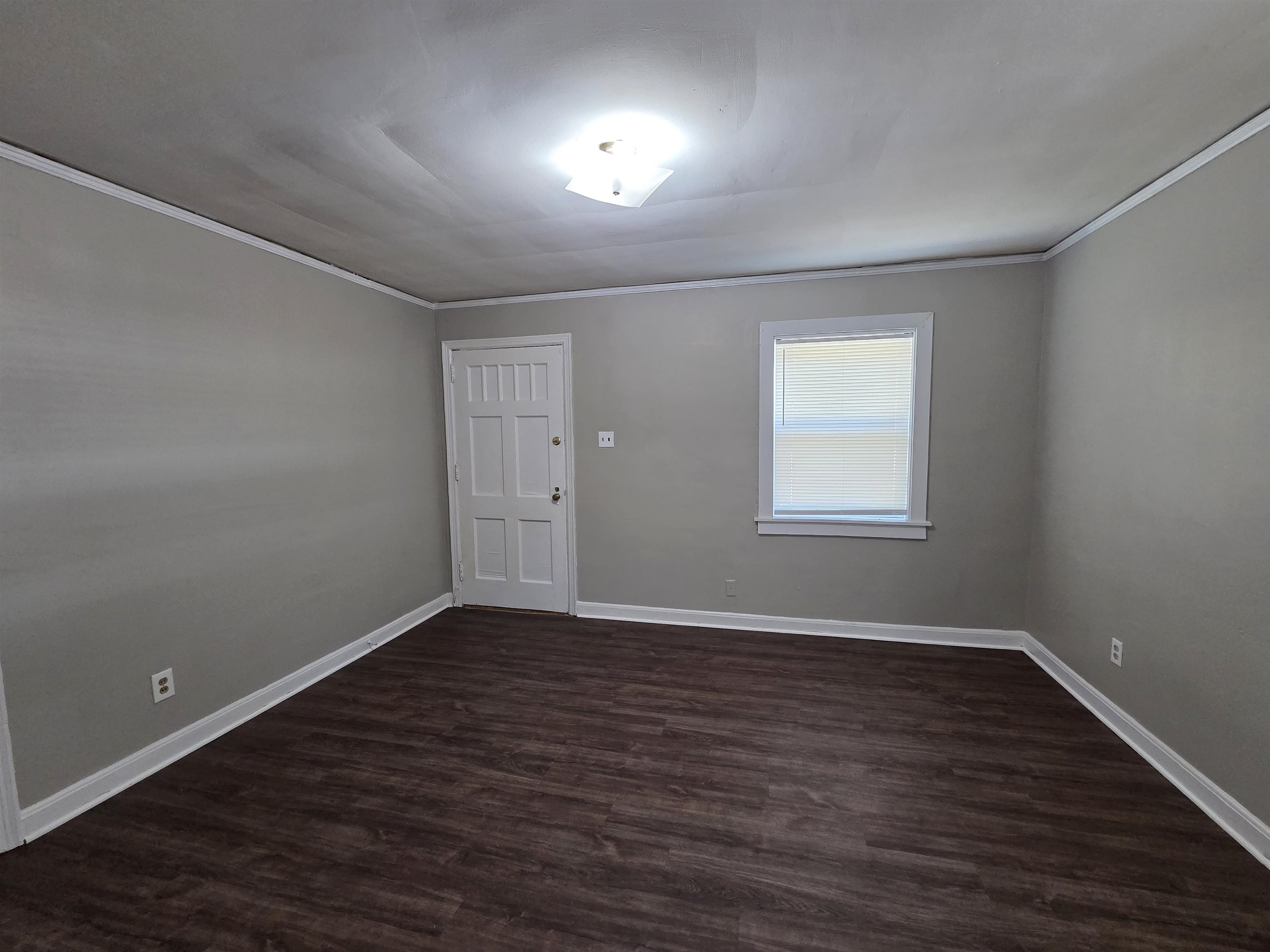 802 North Dunlap Street Memphis, TN 38107 - Photo 4 of 18 Unfurnished room featuring dark wood-type flooring and crown molding