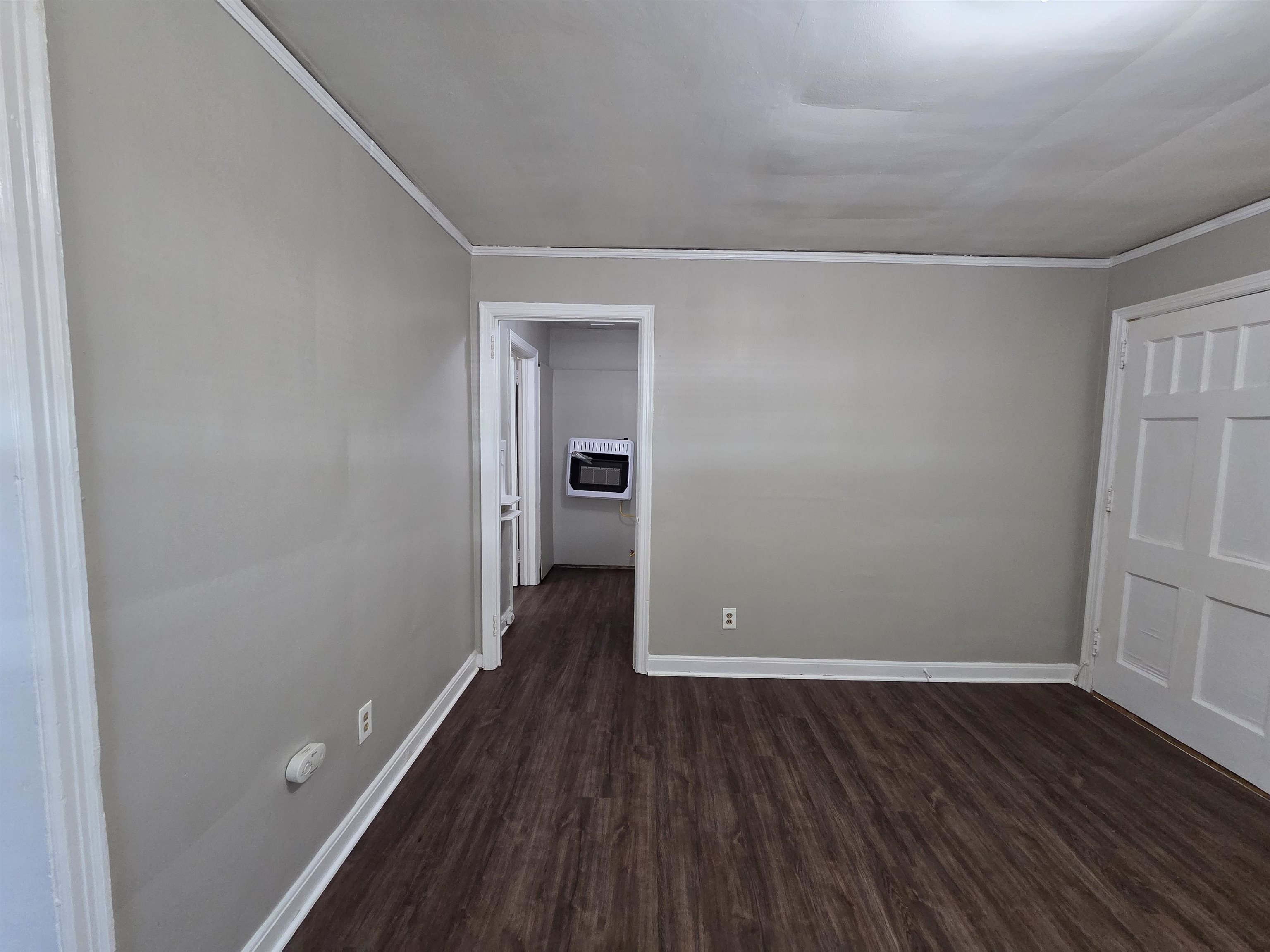802 North Dunlap Street Memphis, TN 38107 - Photo 5 of 18 Spare room with dark wood-style floors, heating unit, and ornamental molding