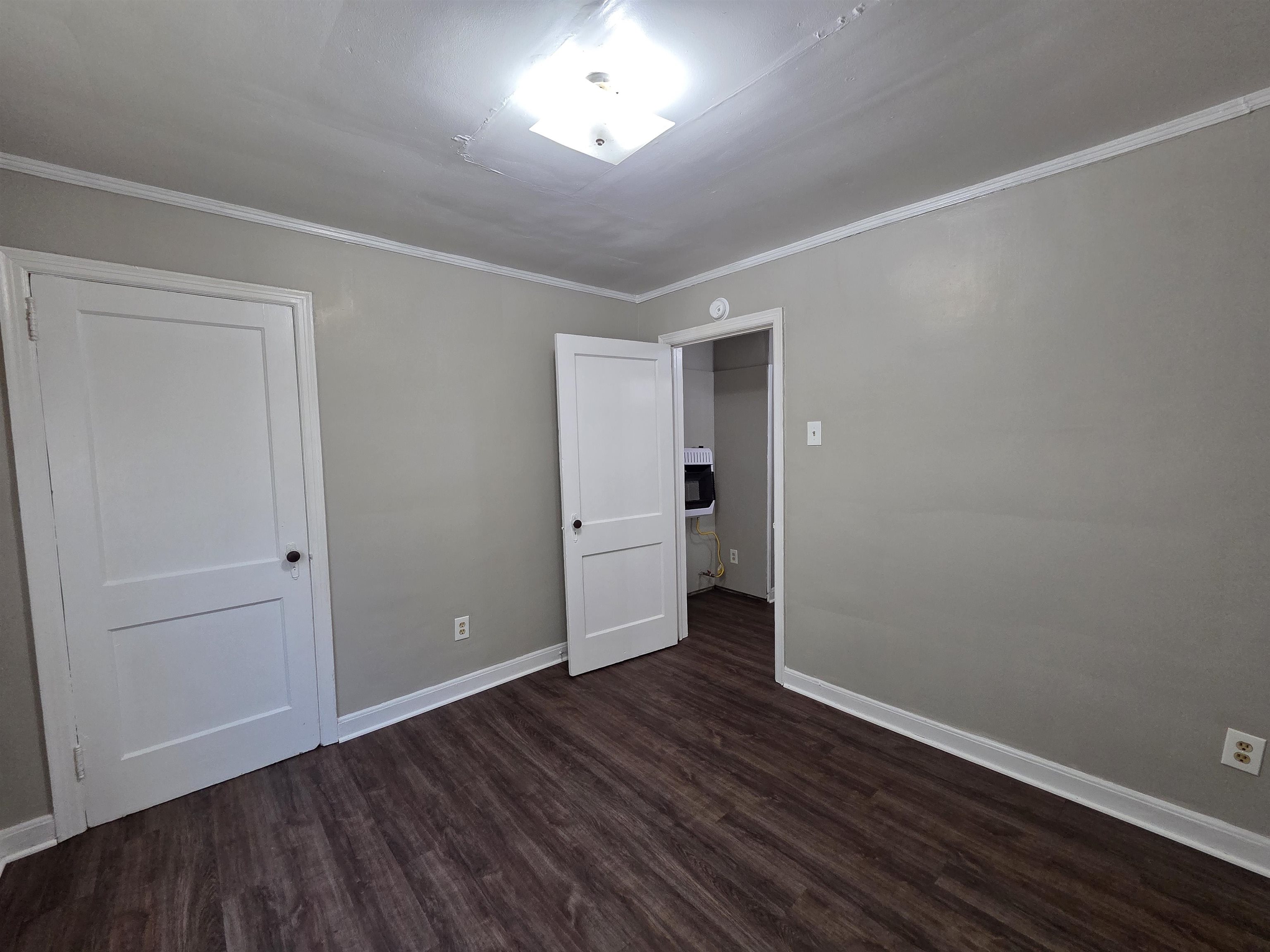 802 North Dunlap Street Memphis, TN 38107 - Photo 7 of 18 Unfurnished bedroom featuring dark wood-type flooring and crown molding