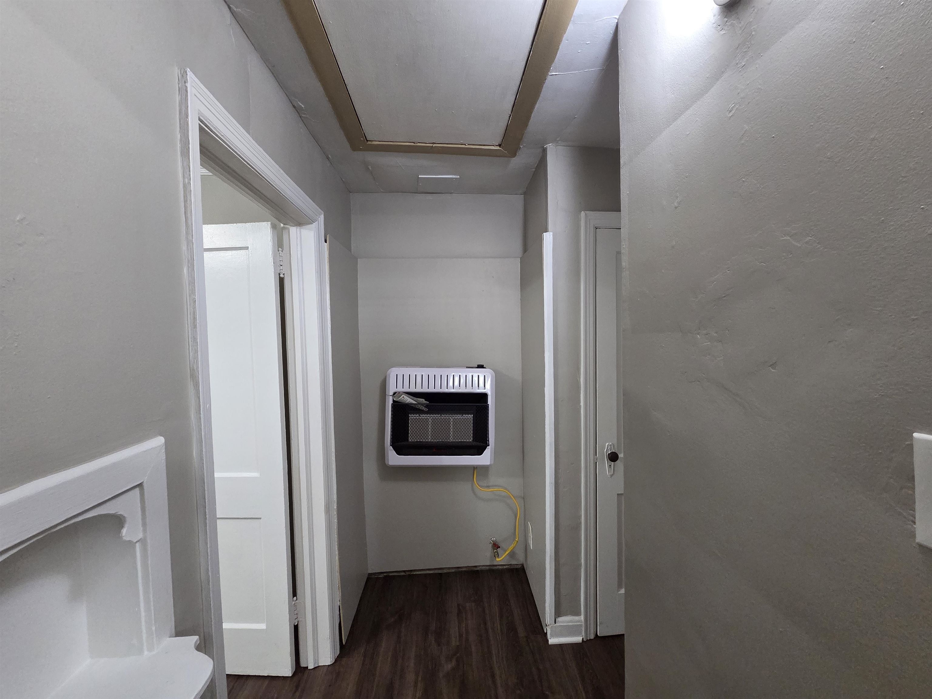 802 North Dunlap Street Memphis, TN 38107 - Photo 8 of 18 Hall with dark wood-type flooring and heating unit