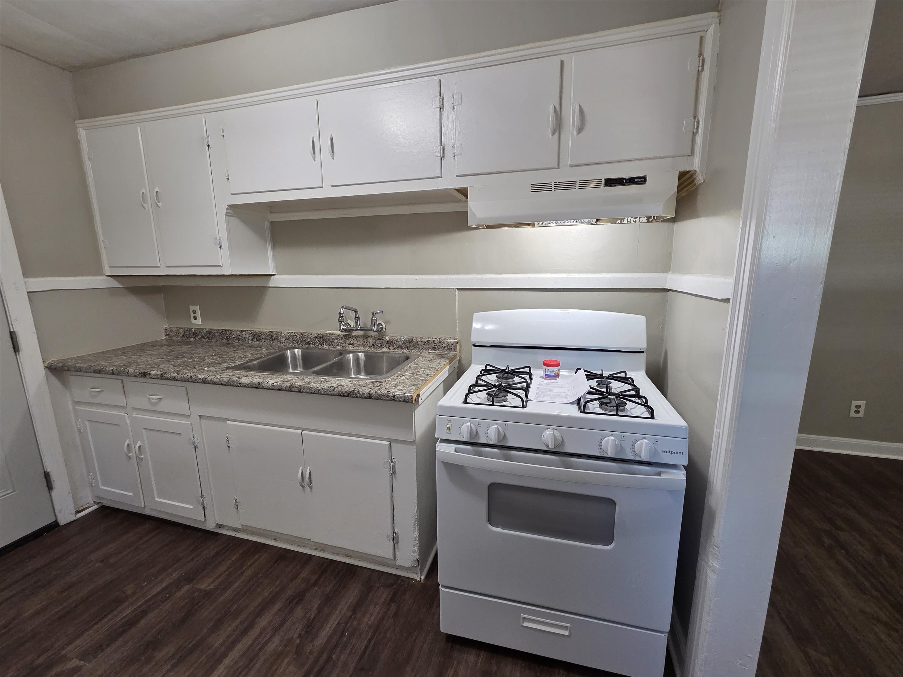 802 North Dunlap Street Memphis, TN 38107 - Photo 9 of 18 Kitchen with white gas range, dark wood-type flooring, and white cabinets