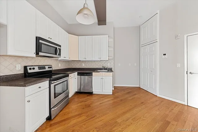 a kitchen with stainless steel appliances granite countertop a stove and a sink
