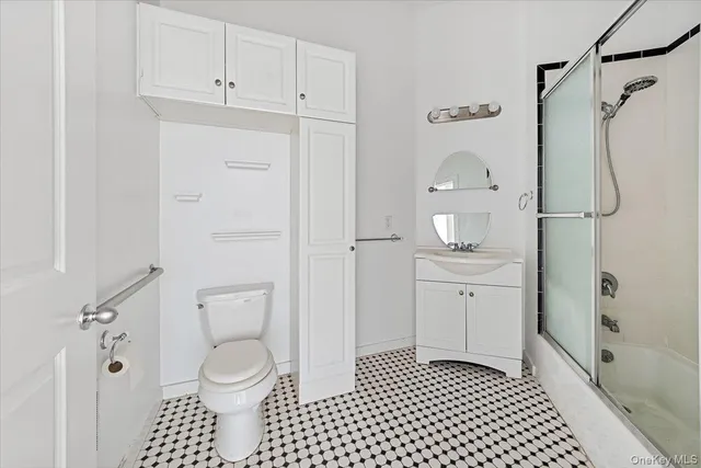 a bathroom with a shower a toilet and a sink