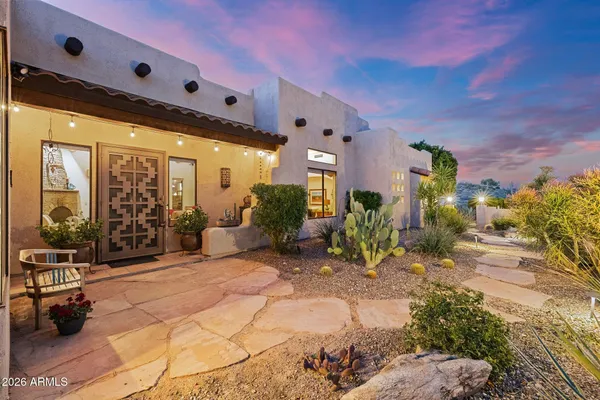 a living room with patio furniture and a fire pit