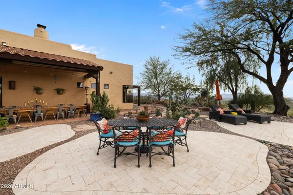 a kitchen with stainless steel appliances granite countertop a stove a sink a refrigerator and a wooden cabinets