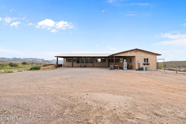 a dining room with furniture a chandelier and wooden floor