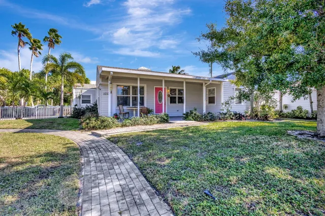a view of backyard of house with green space