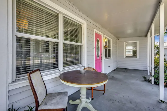 a view of a hallway with wooden floor and a cabinet