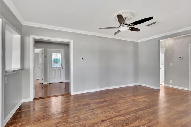 wooden floor in an empty room with a window