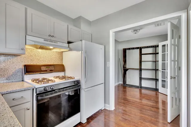 a kitchen with a refrigerator freezer and a stove top oven