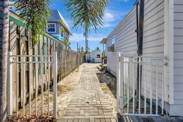 a view of a house with a small yard and wooden fence