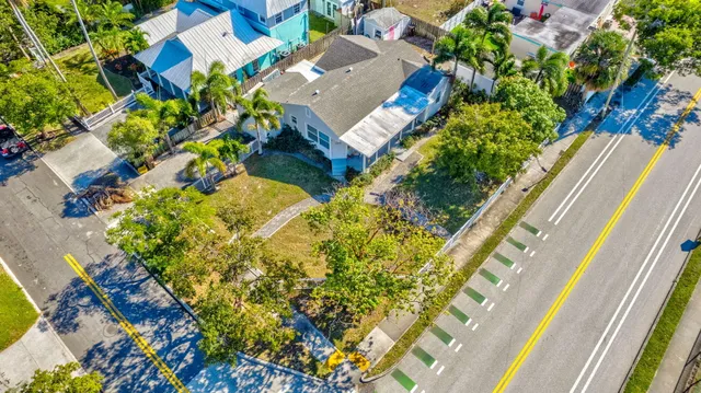 an aerial view of residential houses with outdoor space and swimming pool