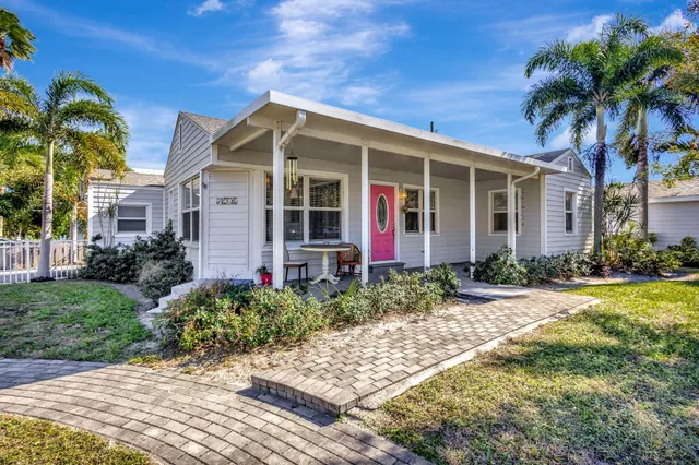 a view of a house with swimming pool and a yard