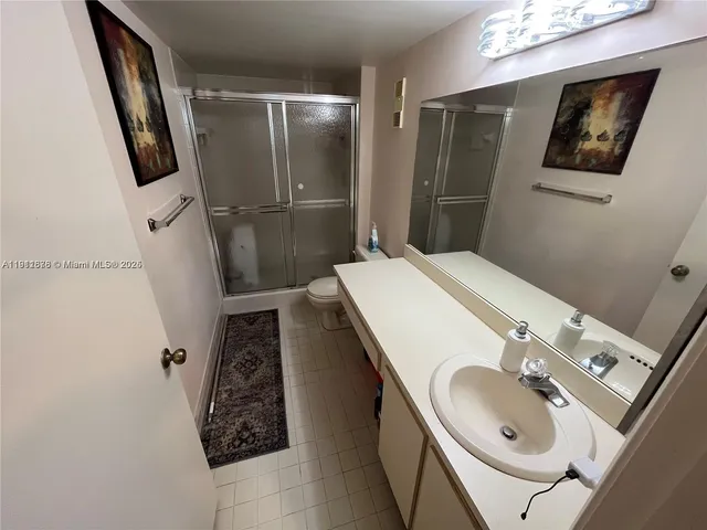 a bathroom with a sink a mirror and shower