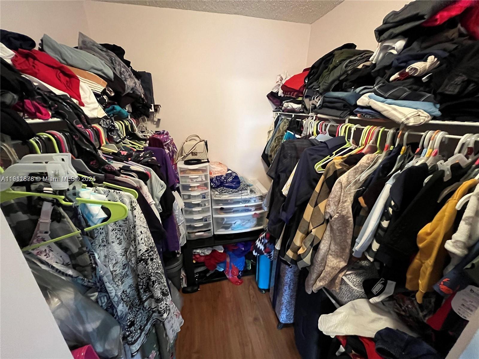2230 North Cypress Bend Drive, Unit 309 Pompano Beach, FL 33069 - Photo 13 of 31 a view of walk in closet with clothes and shoes