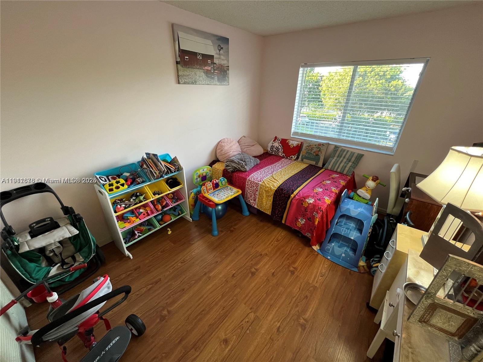 2230 North Cypress Bend Drive, Unit 309 Pompano Beach, FL 33069 - Photo 15 of 31 a bedroom with furniture and a window