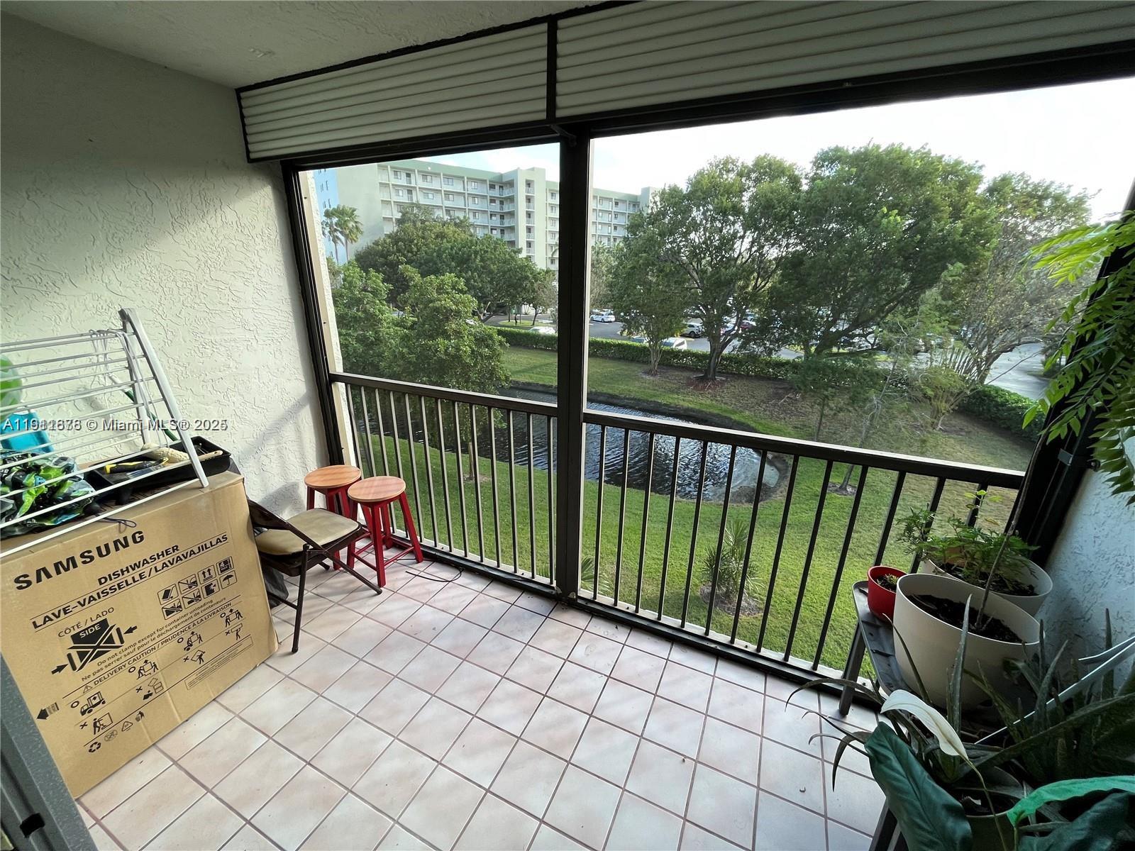 2230 North Cypress Bend Drive, Unit 309 Pompano Beach, FL 33069 - Photo 18 of 31 a view of a two chairs in the balcony