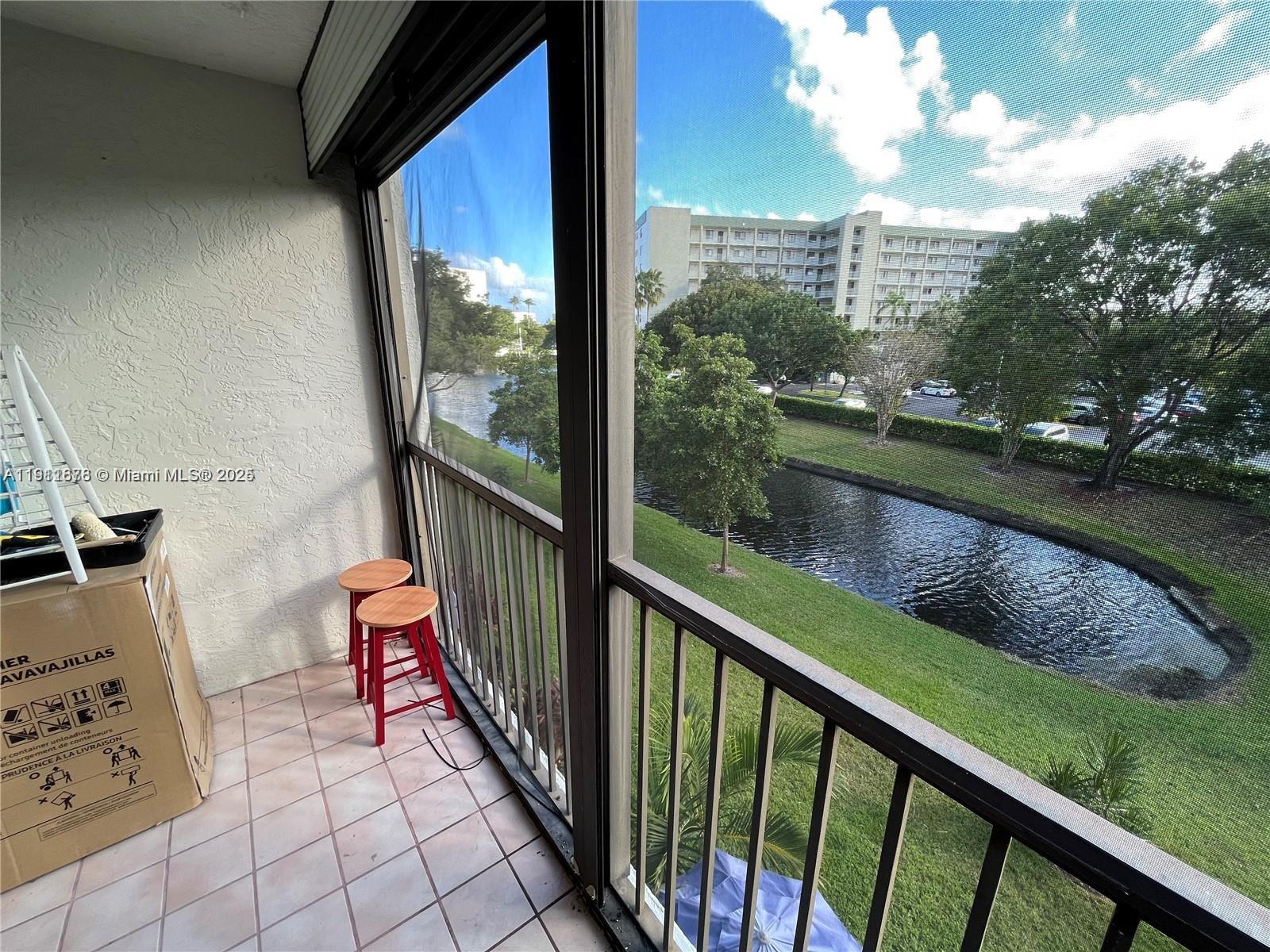 2230 North Cypress Bend Drive, Unit 309 Pompano Beach, FL 33069 - Photo 19 of 31 a view of balcony with yard