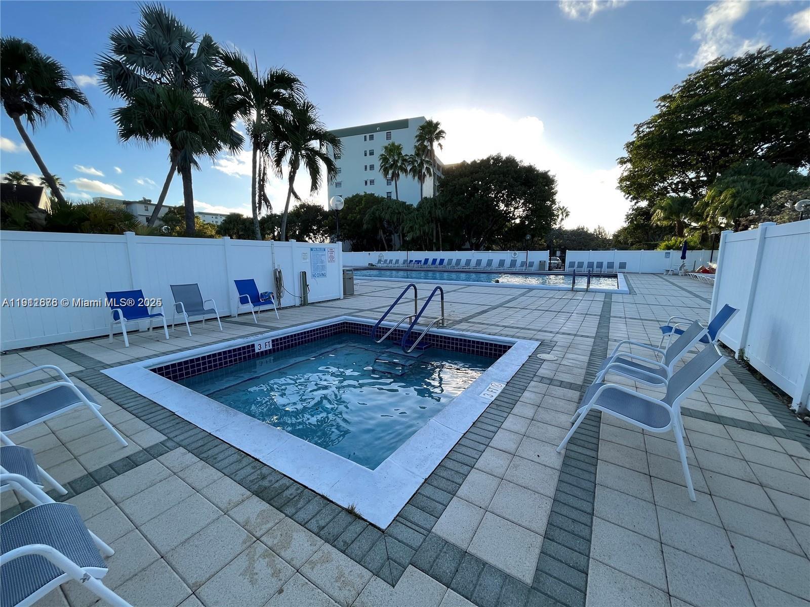 2230 North Cypress Bend Drive, Unit 309 Pompano Beach, FL 33069 - Photo 21 of 31 a view of a backyard and a barbeque