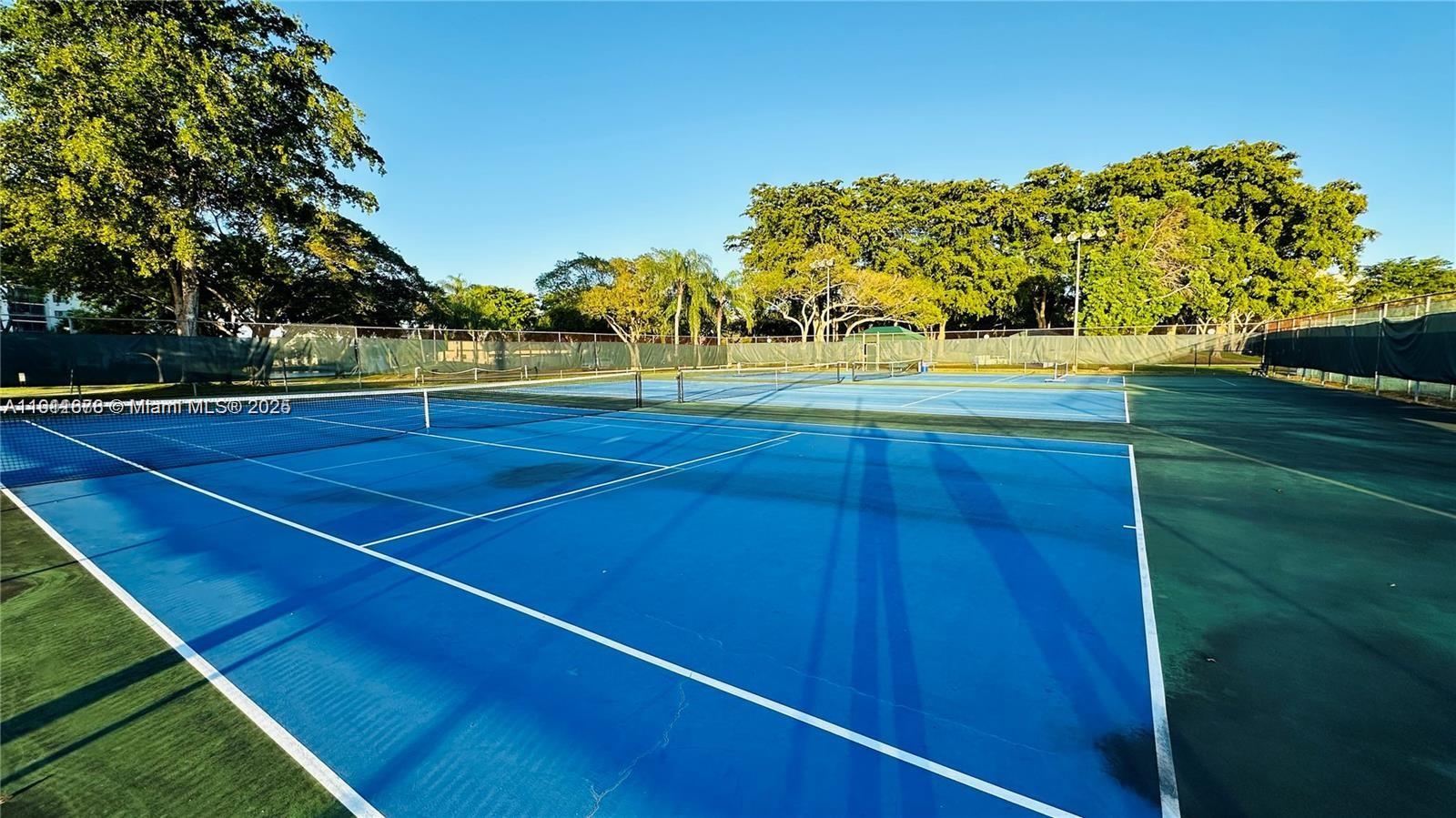 2230 North Cypress Bend Drive, Unit 309 Pompano Beach, FL 33069 - Photo 22 of 31 a view of an outdoor space and tennis court