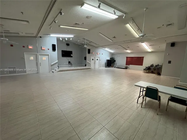 a big room with entryway and wooden floor