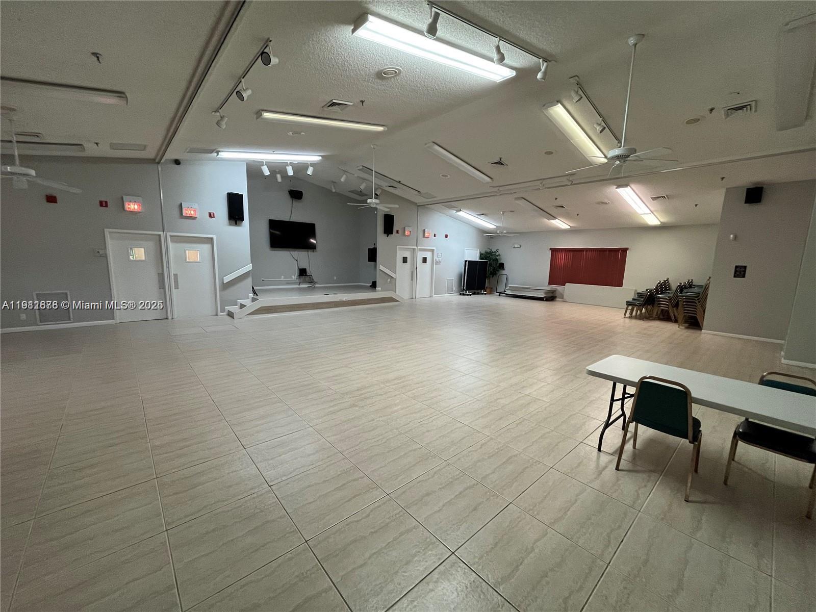 2230 North Cypress Bend Drive, Unit 309 Pompano Beach, FL 33069 - Photo 24 of 31 a big room with entryway and wooden floor