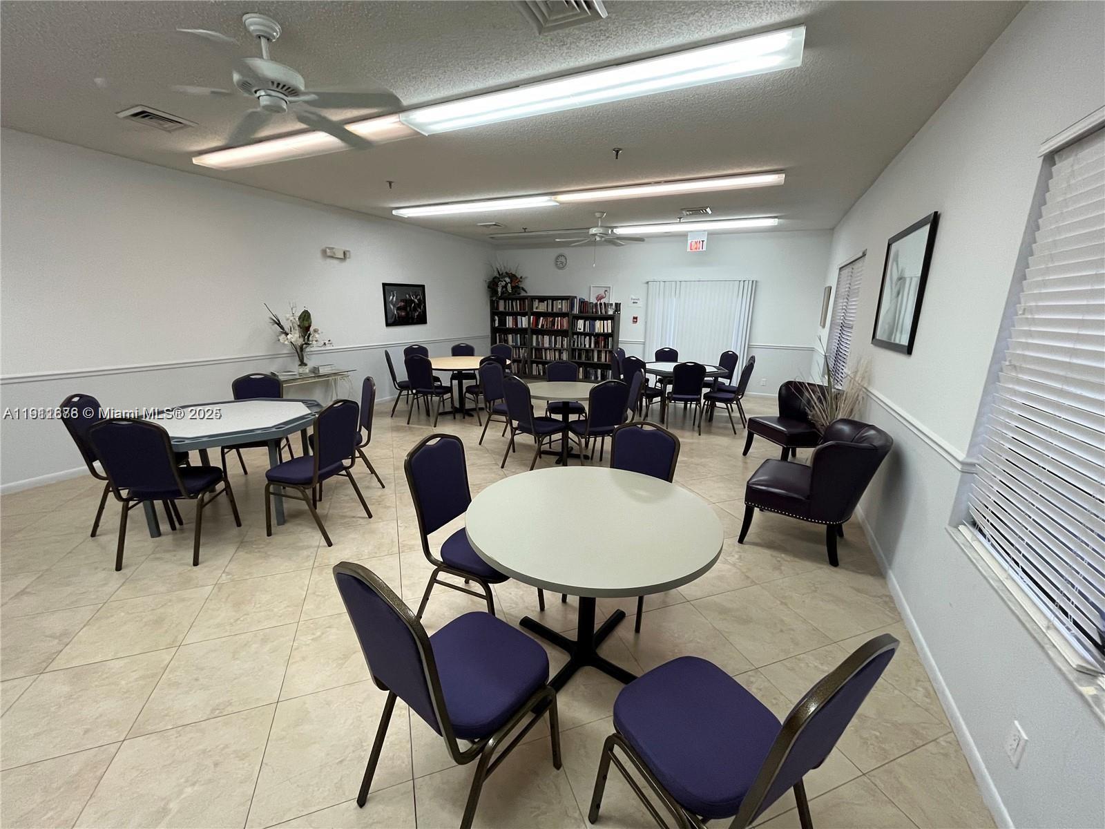 2230 North Cypress Bend Drive, Unit 309 Pompano Beach, FL 33069 - Photo 26 of 31 a living room with lots of furniture a rug and white walls