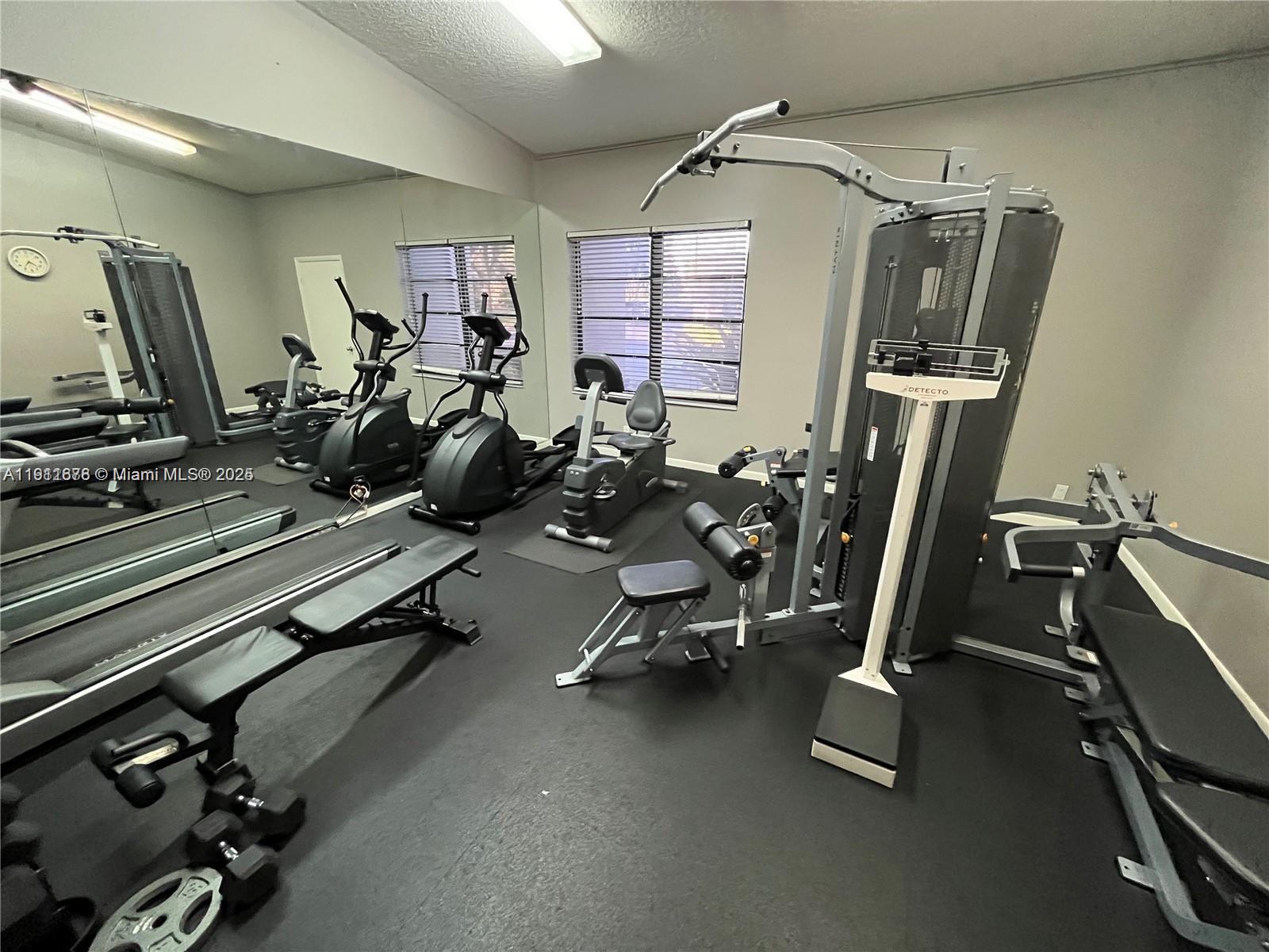 2230 North Cypress Bend Drive, Unit 309 Pompano Beach, FL 33069 - Photo 27 of 31 a view of a room with gym equipment