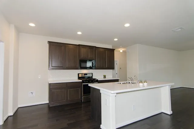a kitchen with a sink and cabinets