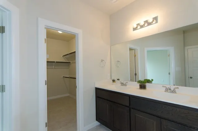 a bathroom with a double vanity sink and mirror