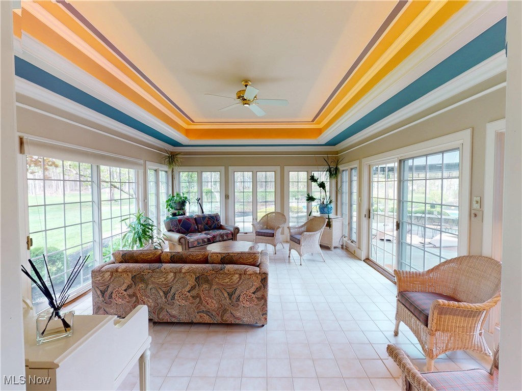 9870 Hobart Road Willoughby, OH 44094 - Photo 17 of 50 Sunroom featuring crown molding, a raised ceiling, tile patterned floors, plenty of natural light, and french doors