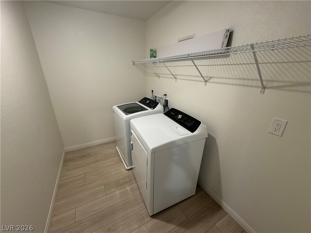 2821 Alcobaca Street Henderson, NV 89044 - Photo 19 of 24 Functional laundry space featuring durable tile flooring and convenient overhead shelving.
