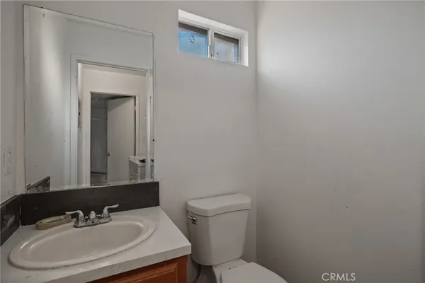 a bathroom with a sink a toilet and mirror