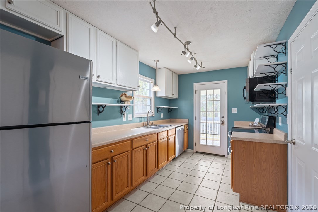 115 Shelby Street Spring Lake, NC 28390 - Photo 14 of 40 a kitchen with stainless steel appliances a refrigerator sink and cabinets