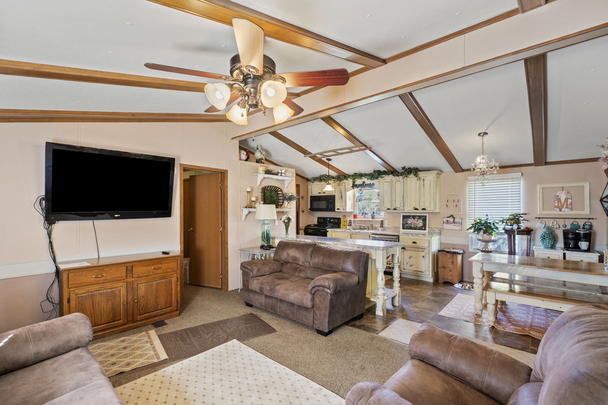 260 Ragland Road Cottontown, TN 37048 - Photo 21 of 36 a living room with furniture a flat screen tv and kitchen view