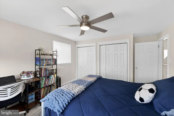 a bedroom with furniture and a window