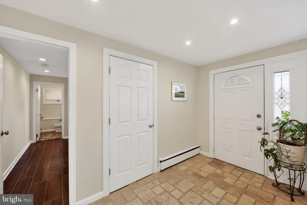 a view of an entryway with wooden floor