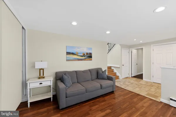a living room with furniture and a wooden floor
