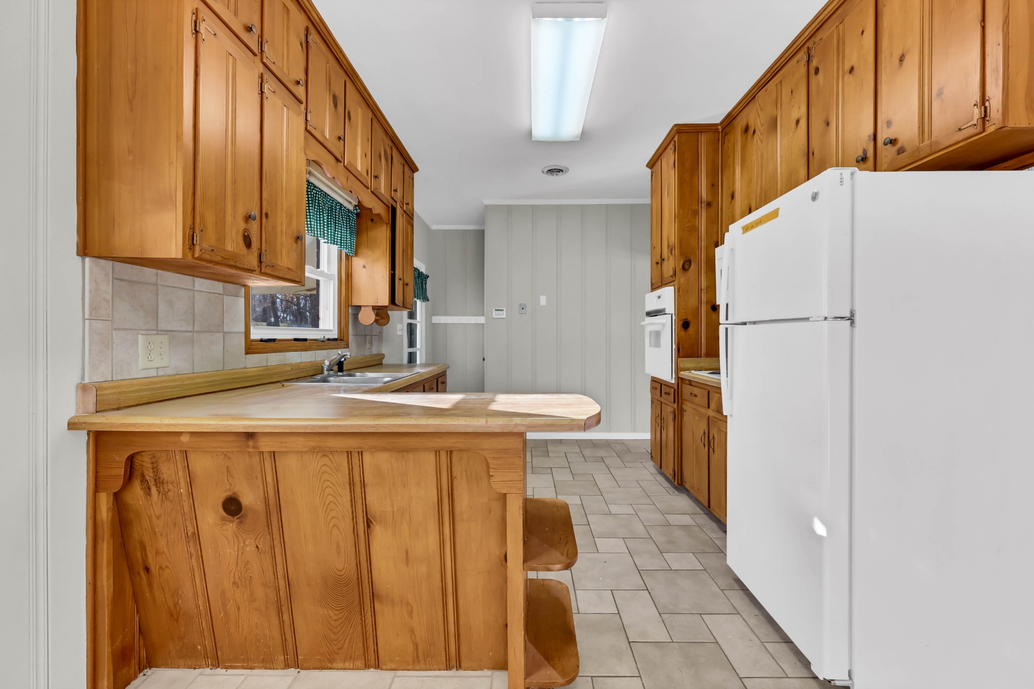 780 Rossview Road Clarksville, TN 37043 - Photo 14 of 40 a kitchen with a sink a cabinetry and a refrigerator