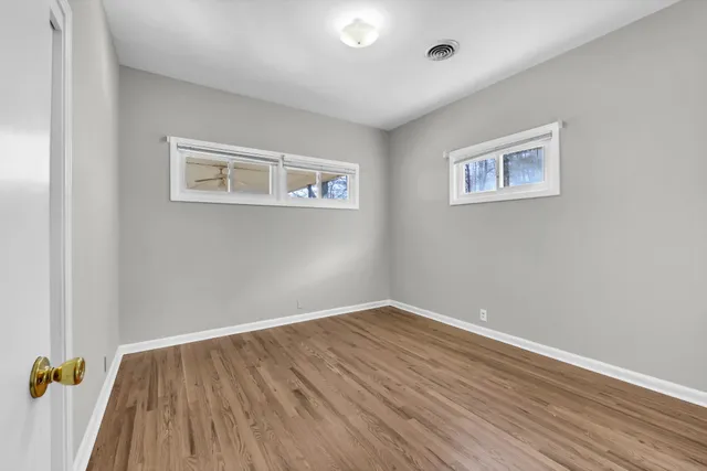 a view of a room with wooden floor and wall painting