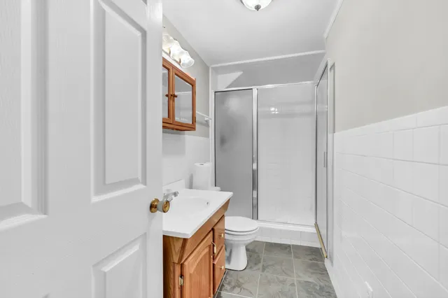 a bathroom with a sink a toilet and shower