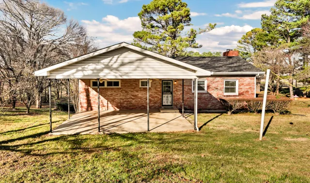 a view of a house with wooden fence